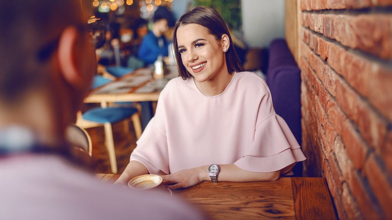 Woman on a date, smiling and seated