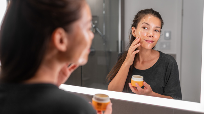 Woman cleansing skin