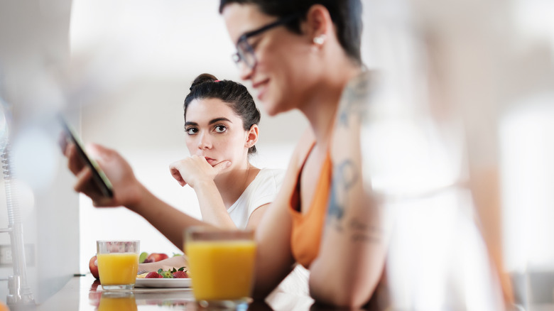 woman looking at woman's phone