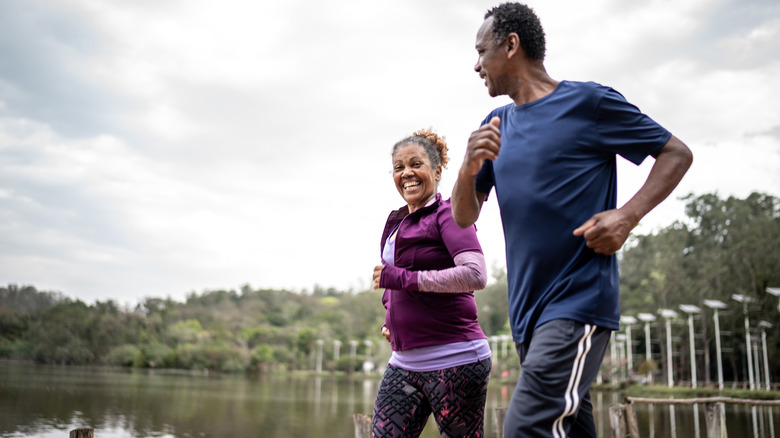 Couple jogs together in park