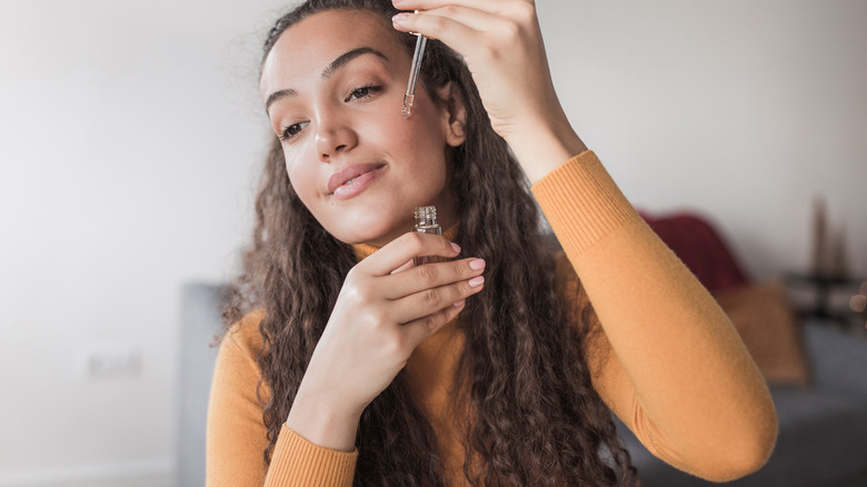 woman applying facial serum