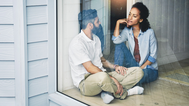 couple talking in window