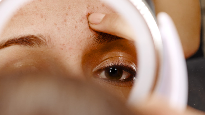 Woman examining reflection