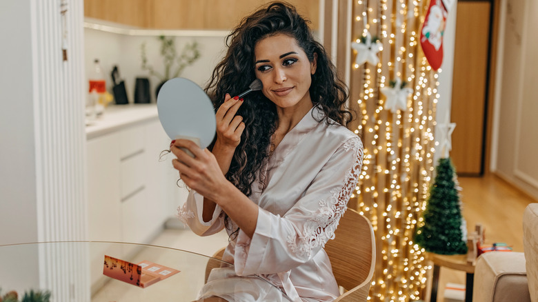Woman applying makeup