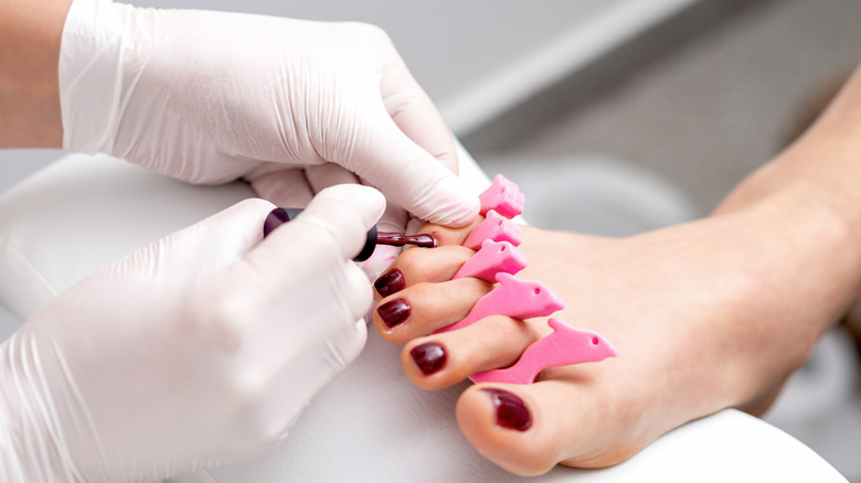 Toenails painted dark red