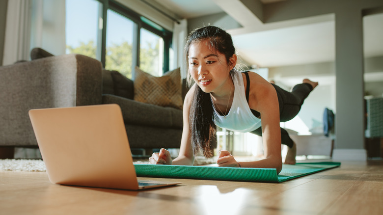 Woman practices yoga at home