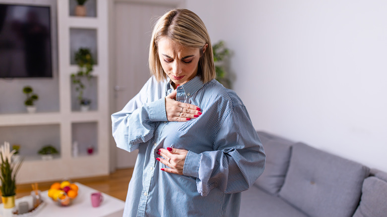 woman conducting breast self exam