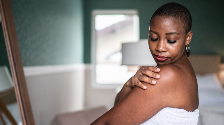 woman looking at skin