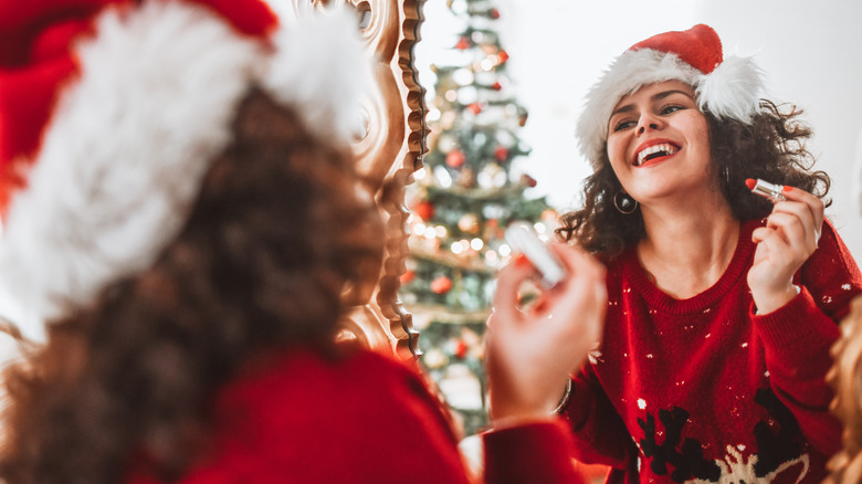 Applying red lipstick