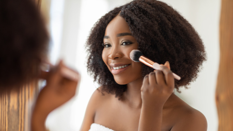 woman applying blush