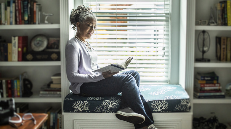 Woman reading outside on bench