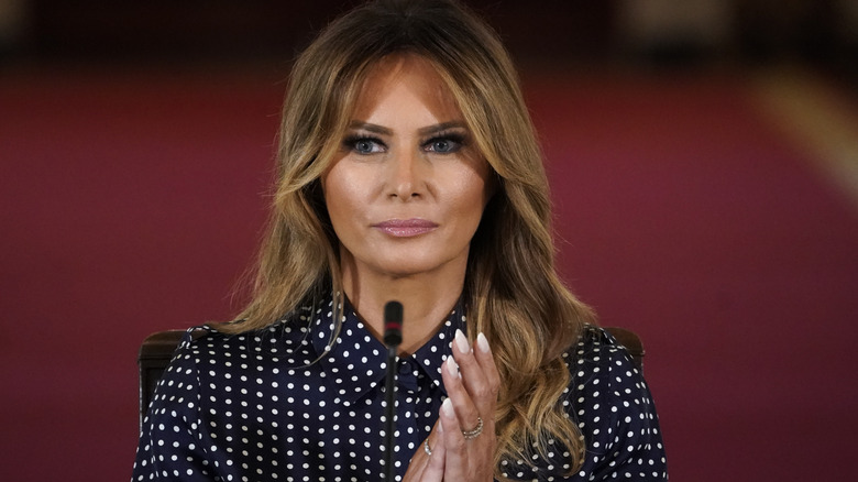 Melania Trump at an event with a polka dot shirt on