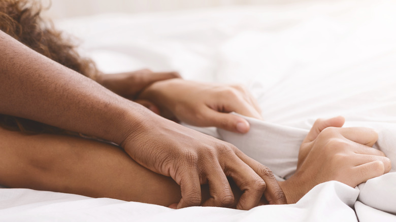 hands grabbing sheet