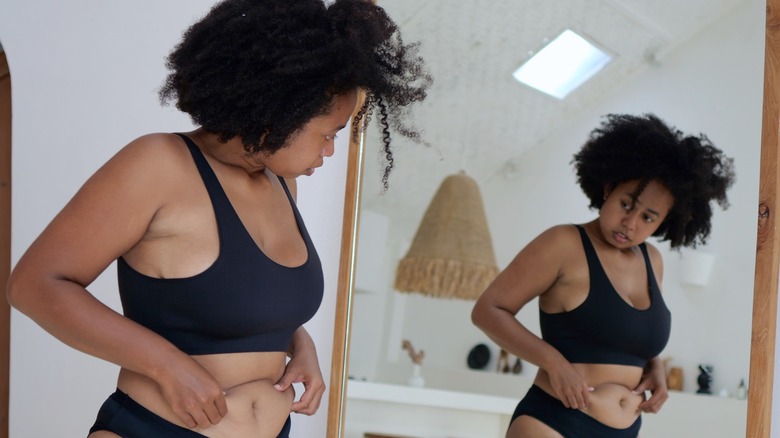 woman holding her stomach