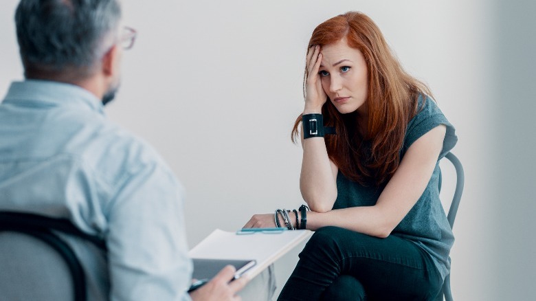Woman looks confused speaking with professional