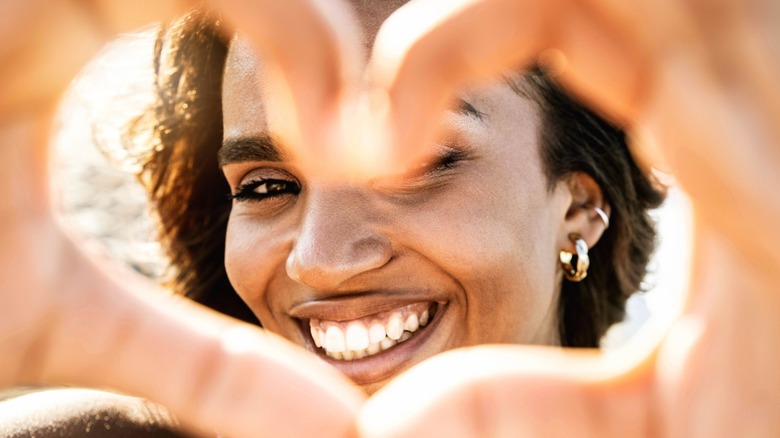 woman making heart with hands