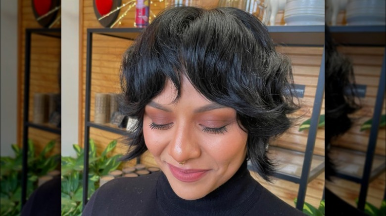 Woman with brown hair, looking down