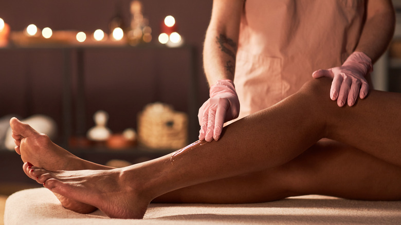 woman having leg sugared