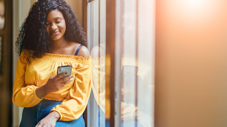 Woman reading text smiling
