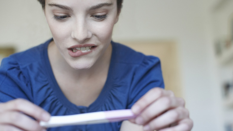 Woman looking at a pregnancy test