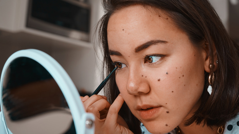 Woman applying makeup