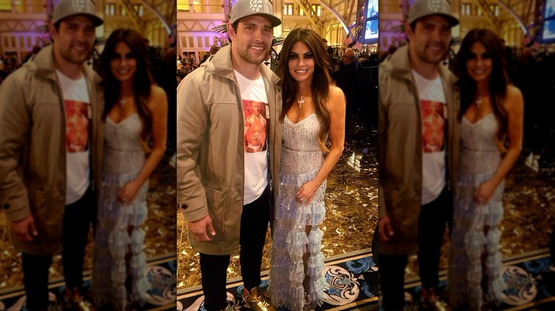 Kimberly Guilfoyle at an event in a white dress with a man with a hat