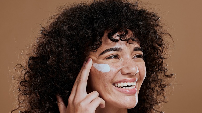 Woman applying sunscreen 