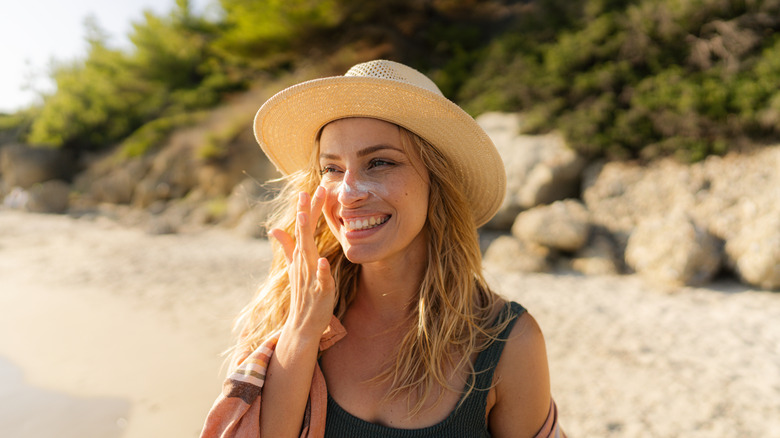 Woman applying sunscreen 