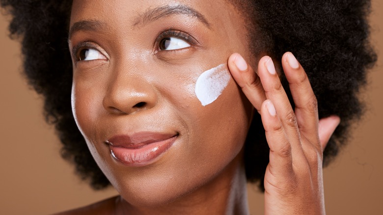 Woman applying sunscreen 
