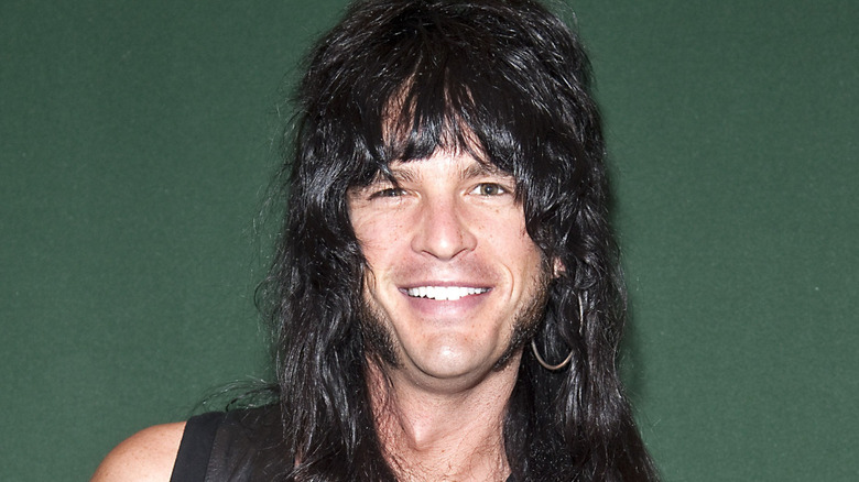 Luc Carl in a leather vest an an event