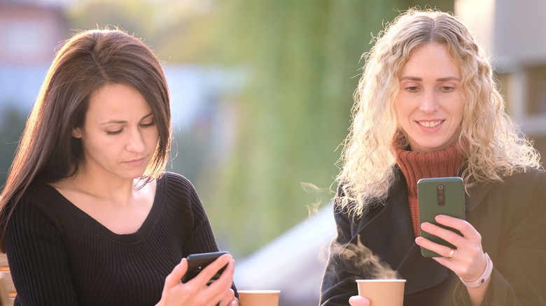 Two women on their phones 