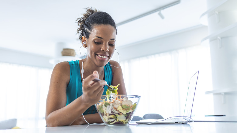 Woman eating salad