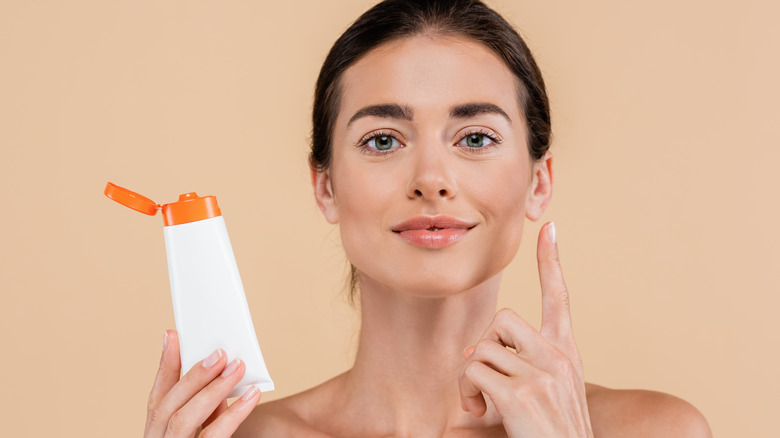 Woman applying sunscreen