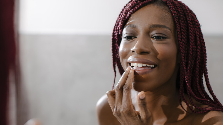 Woman applying lip balm