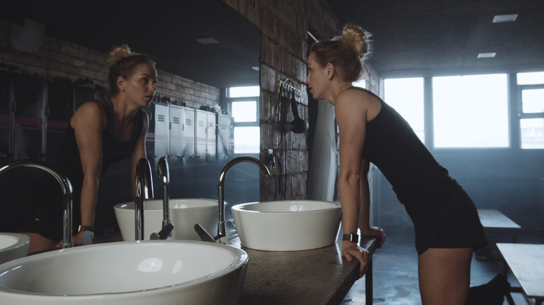 Woman staring in mirror