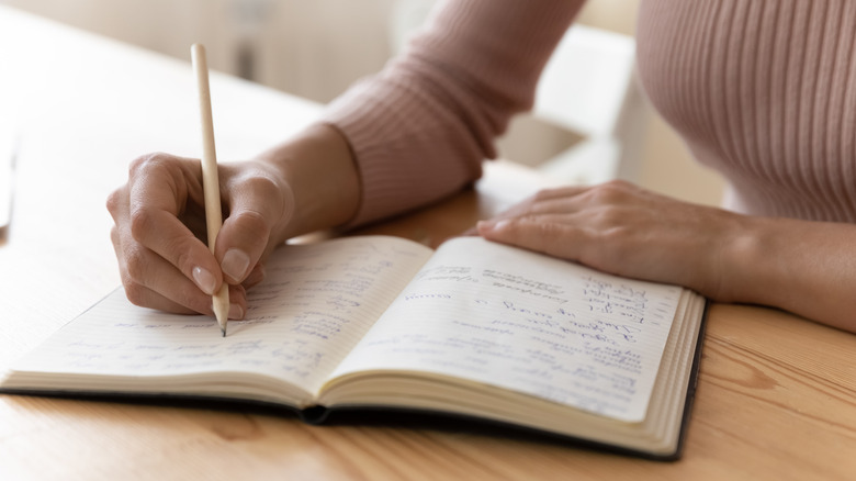 Person writing in a journal