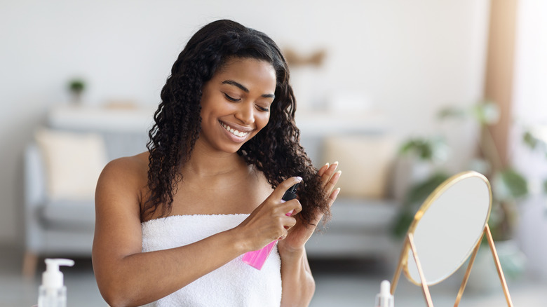 Woman applying product to her hair