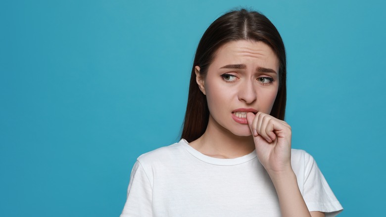 woman biting nails