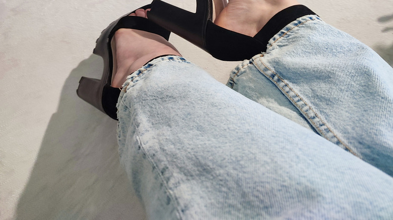 Black open-toe heels with light wash jeans