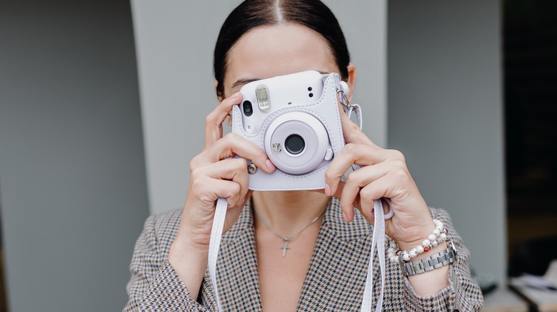 Woman with a Polariod camera