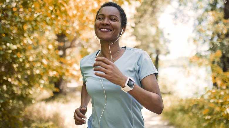Happy woman jogging by herself
