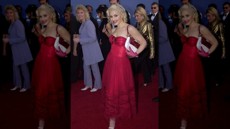 Gwen Stefani on the red carpet and wearing a red dress