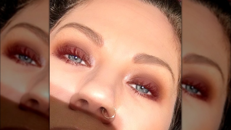 Person wearing red mascara