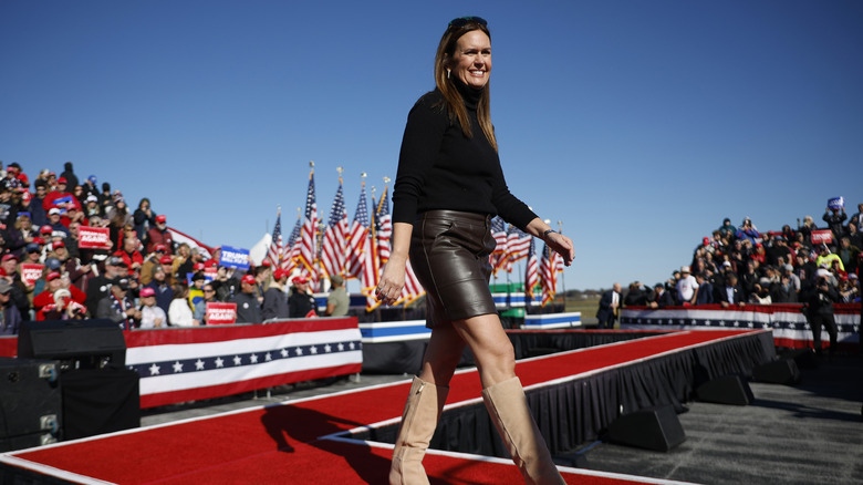 Sarah Huckabee Sanders at an event in a skirt and tan boots