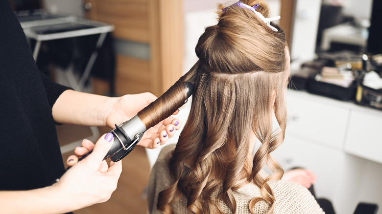 Woman having her hair curled