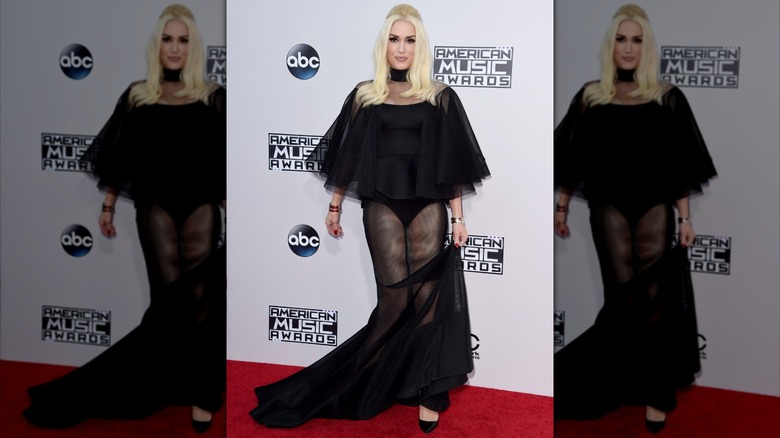 Gwen Stefani on the red carpet and wearing a sheer black dress
