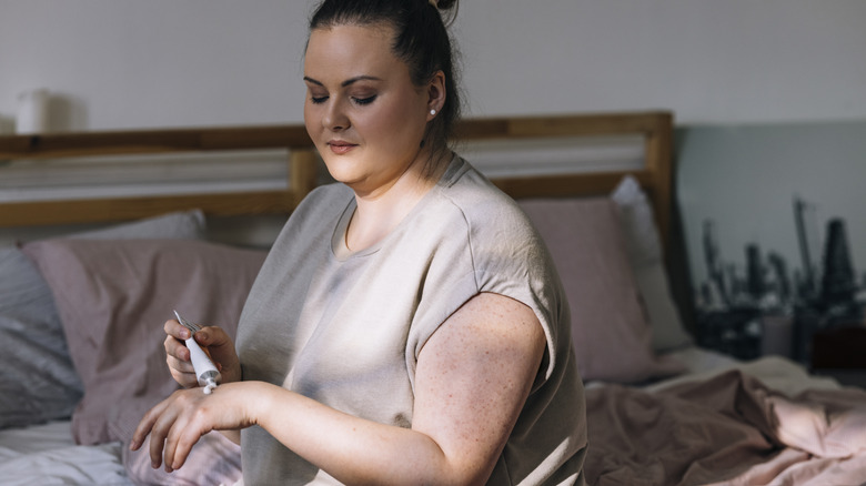 Woman applying hand cream