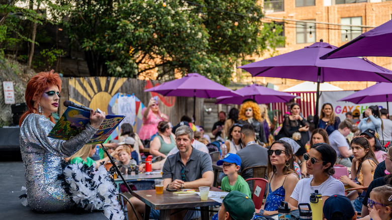 drag queen telling story for crowd