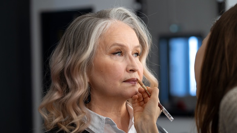 Woman applying lipliner