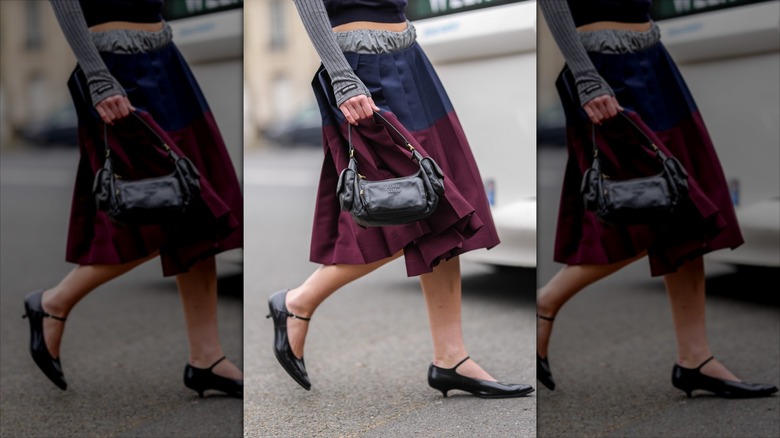 Woman wearing a blue purple midi skirt and kitten heels
